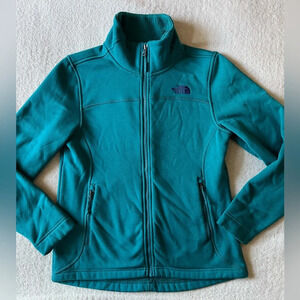 North Face women’s medium zip front, lined. Teal blue. Stretchy material.